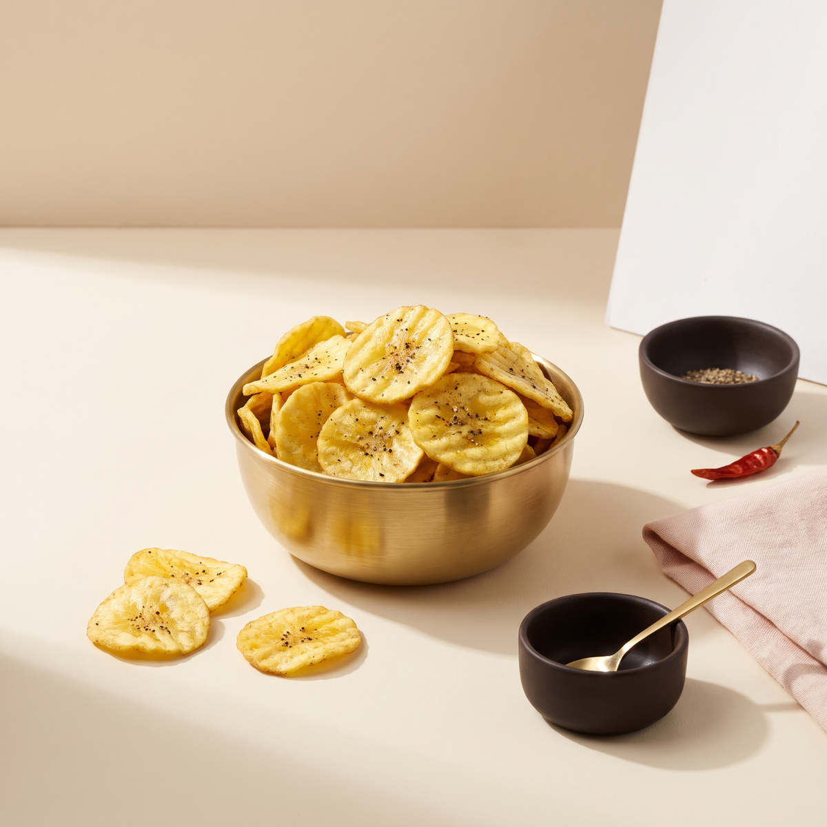 Banana chips in a brass bowl