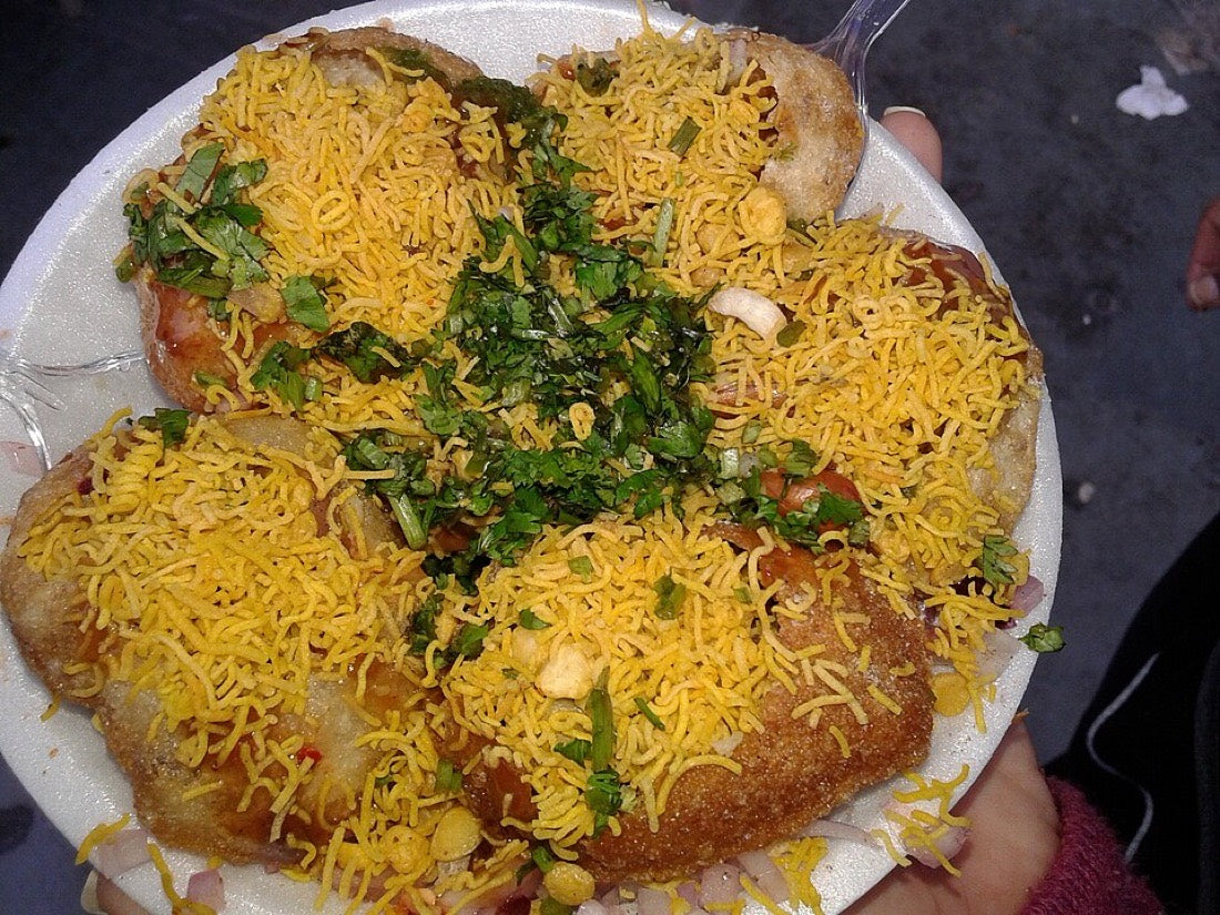 Sev puri topped with chutneys and sev